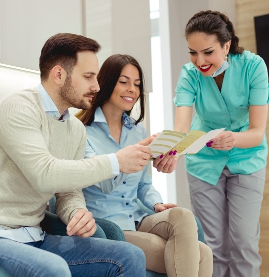patients looking at payment options with staff member